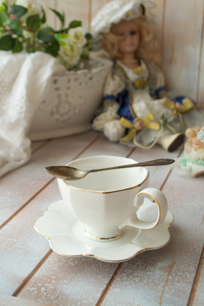 Елегантна антикварна чашка білого чаю на шерстяному столі, вертикальна
 - Фото, зображення