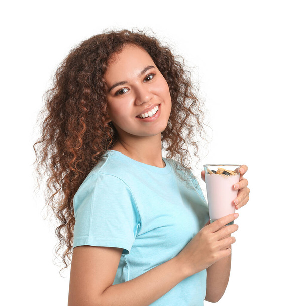 Young woman with tasty yogurt on white background - Foto, imagen
