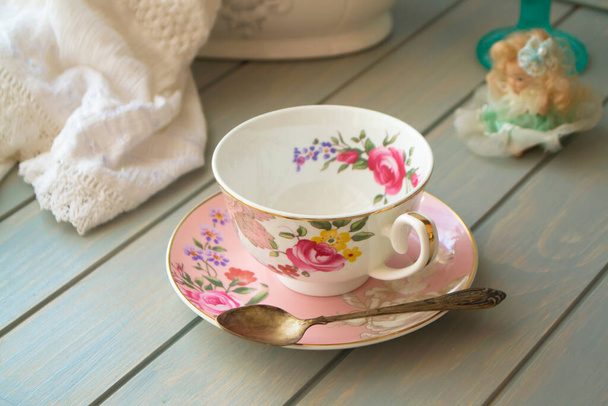 Taça de chá de porcelana vintage rosa na mesa turquesa
. - Foto, Imagem