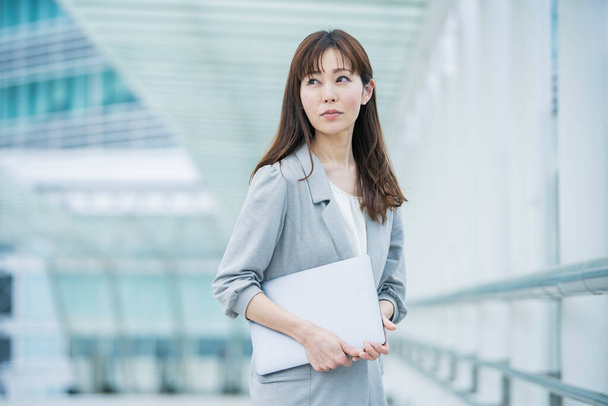 Asiatico (giapponese) donna ufficio lavoratore che lavora all'aperto con un computer portatile
 - Foto, immagini