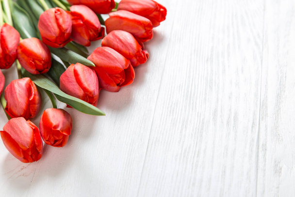 Red tulips on white table, background frame, text blank. Copy space. - Foto, Imagem