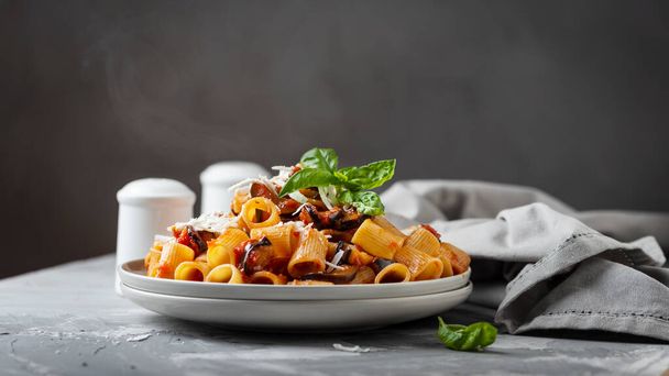 Traditional Italian dish pasta alla norma with eggplant and ricotta, selective focus and slider format - Valokuva, kuva