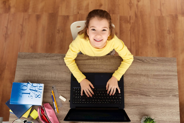 smiling student girl typing on laptop at home - Fotoğraf, Görsel