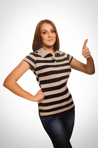 女性女の子はいストライプ t シャツ感情で分離された肯定的な兆候親指を示しています. - 写真・画像