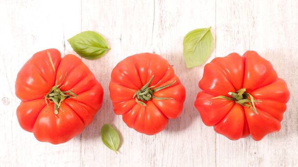 red fresh tomato with basil - 写真・画像