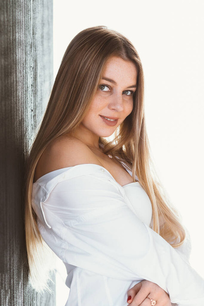 Close up portrait of young woman in white shirt - Fotó, kép