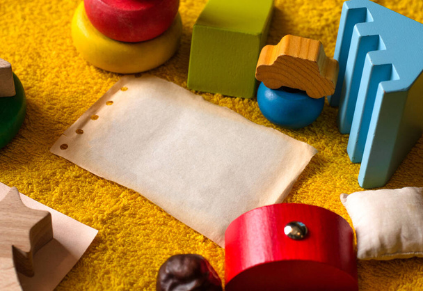 fotó a mock up összetétele szöveg gyermekek színes játékok papír és különböző tárgyak sárga frottír háttér közeli - Fotó, kép