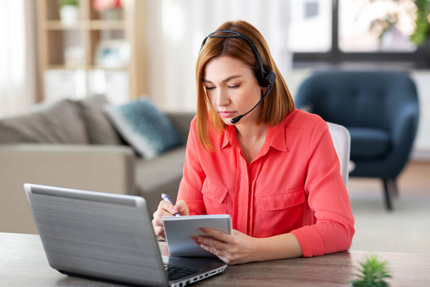 woman with headset and laptop working at home - Photo, Image