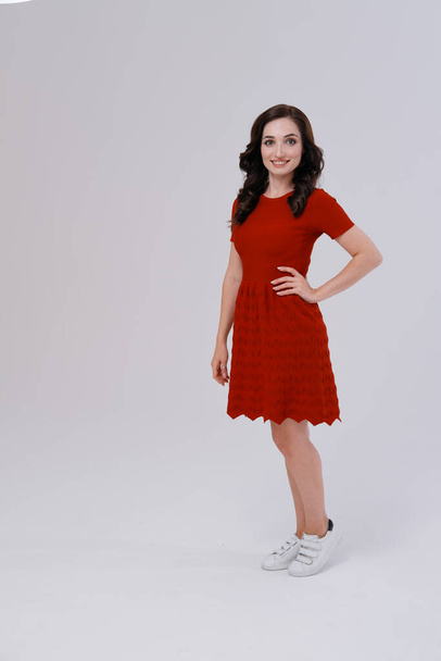 Studio portrait of woman in red dress - Photo, Image