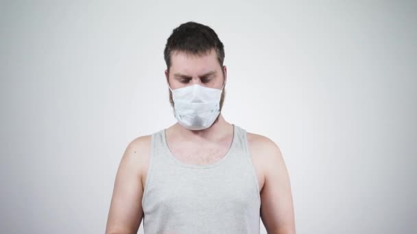 The guy in the medical mask is sick, blowing his nose into handkerchief - Πλάνα, βίντεο