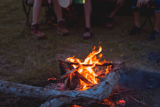 Friends group travel campfire together in forest with backpack and tent at nature outdoor relax,rest near mountain lake river - Фото, зображення