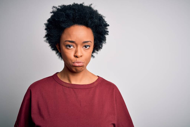 Young beautiful African American afro woman with curly hair wearing casual t-shirt standing depressed and worry for distress, crying angry and afraid. Sad expression. - Fotografie, Obrázek