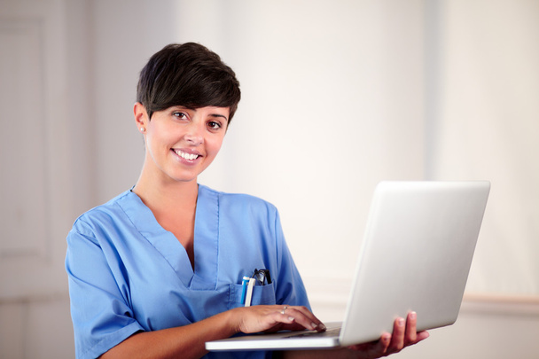 Pretty medical lady working on her laptop - Photo, image