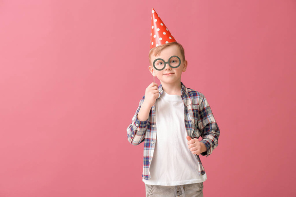 Cute little boy celebrating Birthday on color background - Fotó, kép