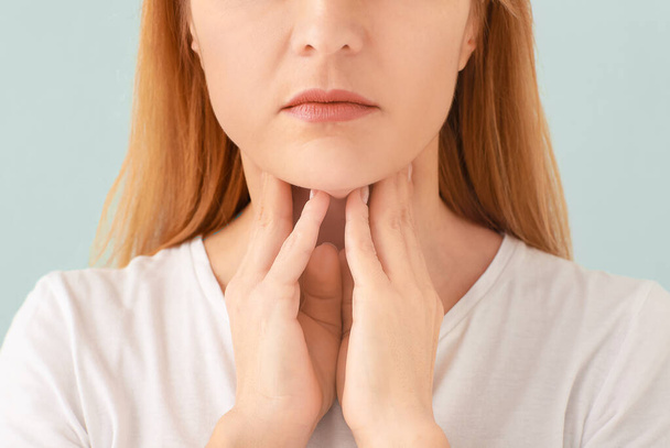 Woman with thyroid gland problem on light background - Foto, Imagem