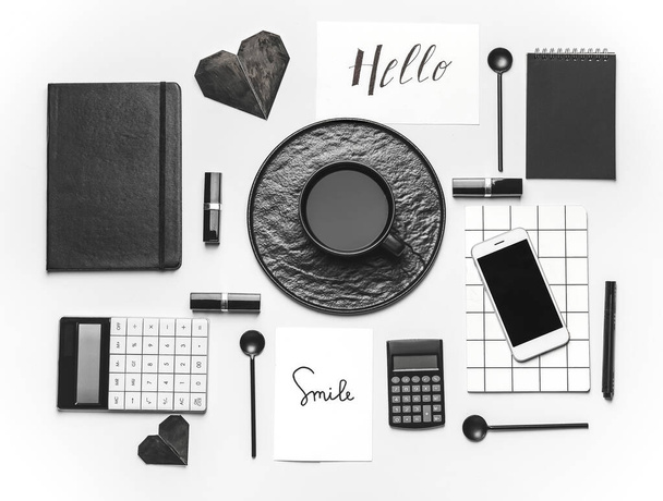Komposition mit Tasse Kaffee, Notizbüchern und Taschenrechnern auf weißem Hintergrund - Foto, Bild