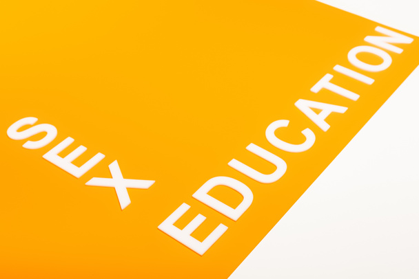 sex education lettering on orange surface isolated on white  - Fotografie, Obrázek