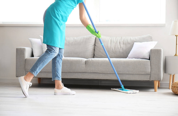 Young woman mopping floor in room - Photo, Image