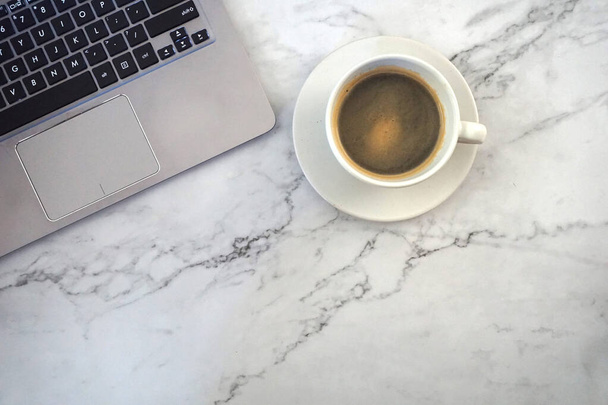 cup of coffee and laptop, with marble background - Φωτογραφία, εικόνα