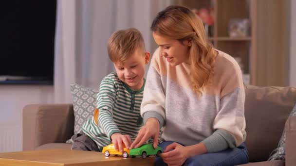 mother and son playing with toy cars at home - Séquence, vidéo