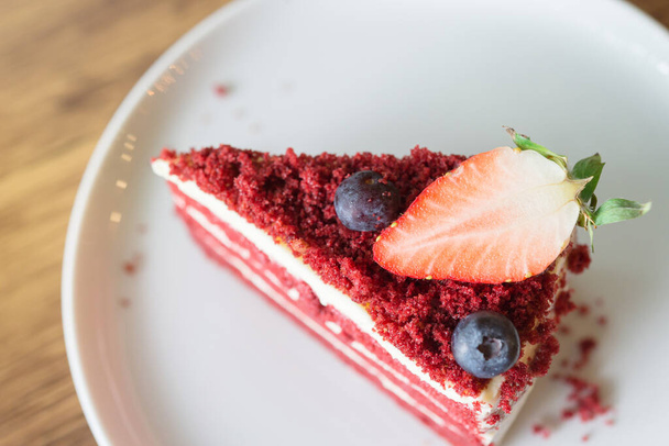 Red Velvet Cheesecake on wooden table in cafe. - Photo, Image