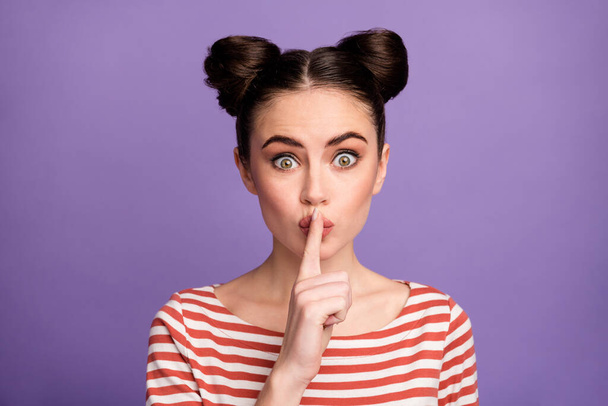 Closeup photo of pretty funny lady two cute buns hold finger on lips going to say tell novelty secret speech wear white red casual striped shirt isolated purple pastel color background - Foto, Imagem