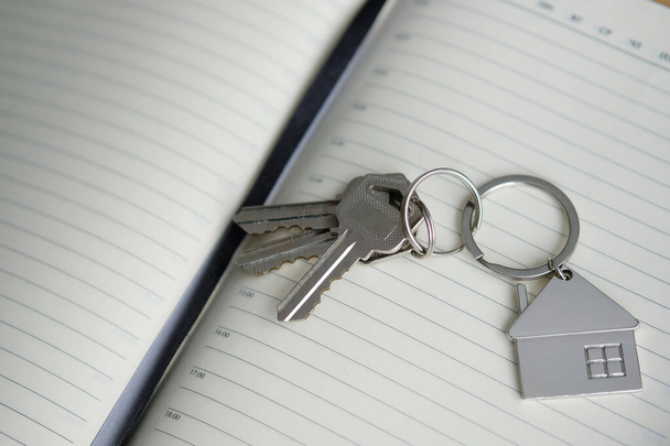 Buying a new home. Keys to the real estate on notepad. - Photo, Image