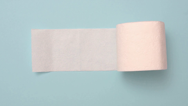 Stop motion animation of white toilet paper on blue - Video