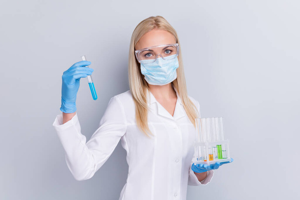 Close-up portrait of her she nice attractive girl medic anesthetist epidemic pandemic biologist holding in hands bulbs remedy cure substance examine expertise isolated on grey pastel color background - Foto, Imagem