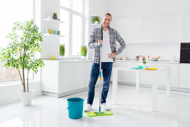 Full size photo of positive cheerful guy want his apartment be clean hold mo enjoy do household chores wear good look clothes in kitchen indoors - Fotó, kép