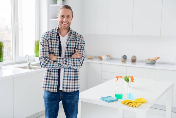Portrait of his he nice attractive cheerful cheery content guy husband cleaning service worker perfect housework finish done folded arms in modern light white interior style kitchen - Фото, зображення