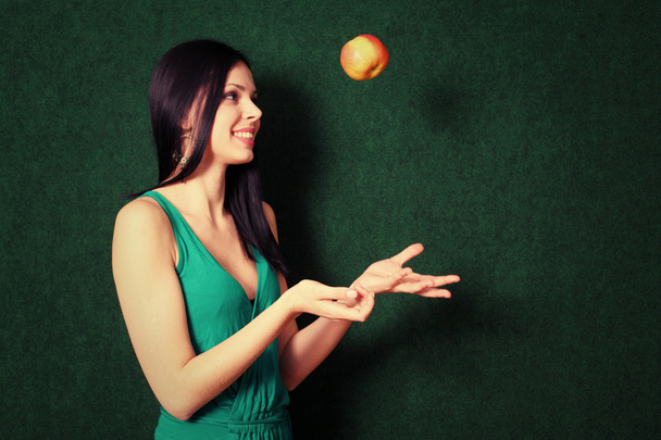 Female with an orange in her hands - Photo, Image