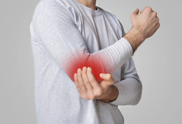 Sports trauma. Man suffering from pain in elbow - Foto, Imagen