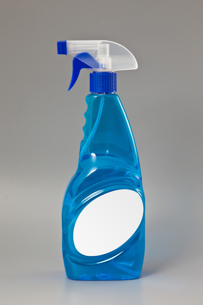 Blue transparent detergent spray bottle Isolated on gray - Fotoğraf, Görsel