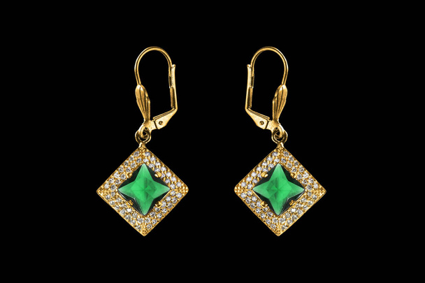 Pair of elegant emerald gold earrings with diamonds on black background - Foto, Bild