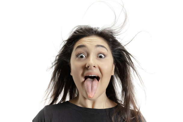 Smiling girl opening her mouth and showing the long big giant tongue isolated on white background, crazy and attracted - Φωτογραφία, εικόνα