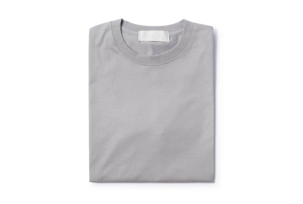 Grey folded t-shirt isolated on white background with clipping path. - Photo, Image