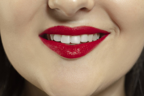 Close-up female mouth with bright red gloss lips make-up. Cosmetology, dentistry and beauty care, emotions - Φωτογραφία, εικόνα