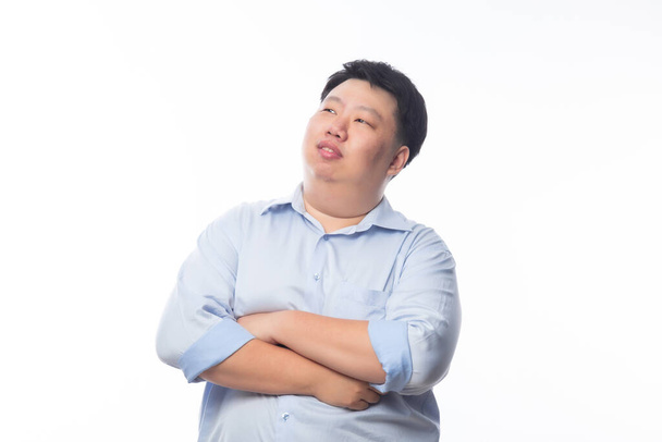Asian Fat Man in blue shirt arm crossed and looking to copyspace with happy face isolated on white background. - Fotografie, Obrázek