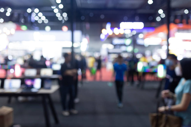 Abstract blur people in exhibition hall event trade show expo background. Business convention show, job fair, or stock market. Organization or company event, commercial trading, or shopping mall marketing advertisement concept. - Photo, Image