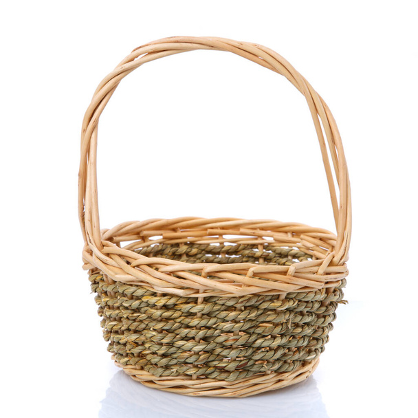 Wicker basket with a tall handle from a natural vine for harvesting. Isolated on white. - Photo, Image