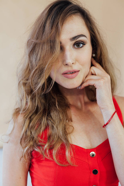 Portrait of a beautiful fashionable woman in a red dress - Photo, Image