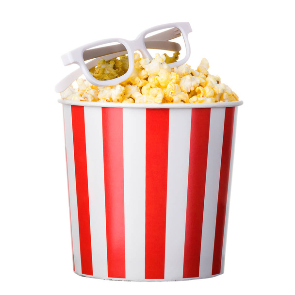 Paper striped bucket with popcorn and 3D glasses isolated on white background with clipping path. Concept of cinema or watching TV. - Photo, image