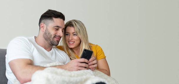Banner of couple using smartphone together. Blank copy space background. - Foto, afbeelding