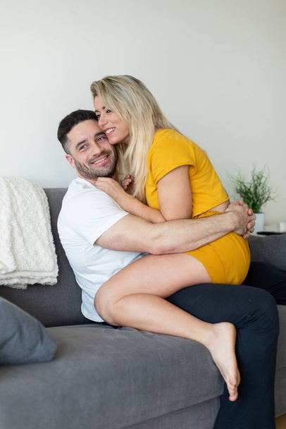 Young happy casual couple hugging at home. - Photo, image