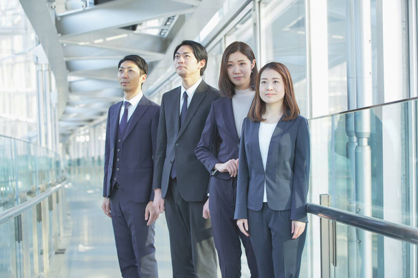 Mladí muži a ženy tým asijských podnikatelů v oblecích - Fotografie, Obrázek
