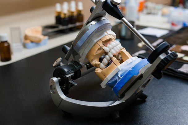 Dental technician tools with articulator in dental laboratory - Photo, Image