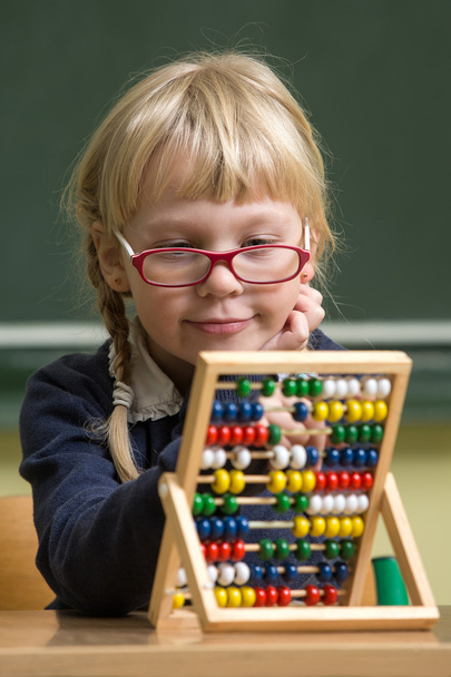 Child at school, girl in school working with abacus - Фото, изображение