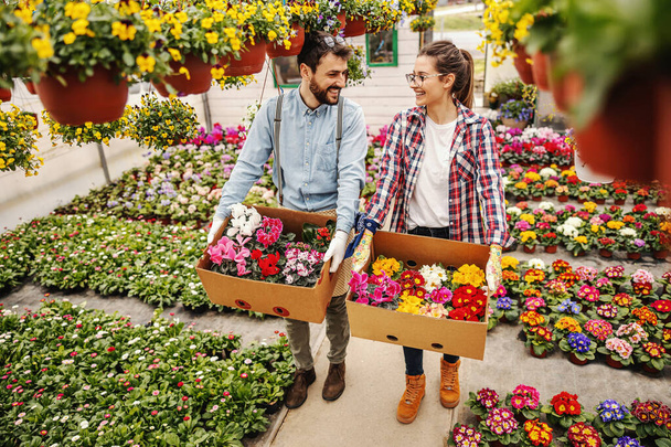 Zwei fleißige Unternehmer halten Blumenkästen mit Aufträgen. - Foto, Bild