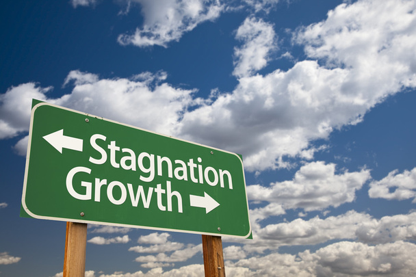 Stagnation or Growth Green Road Sign Over Clouds and Sky - Photo, Image